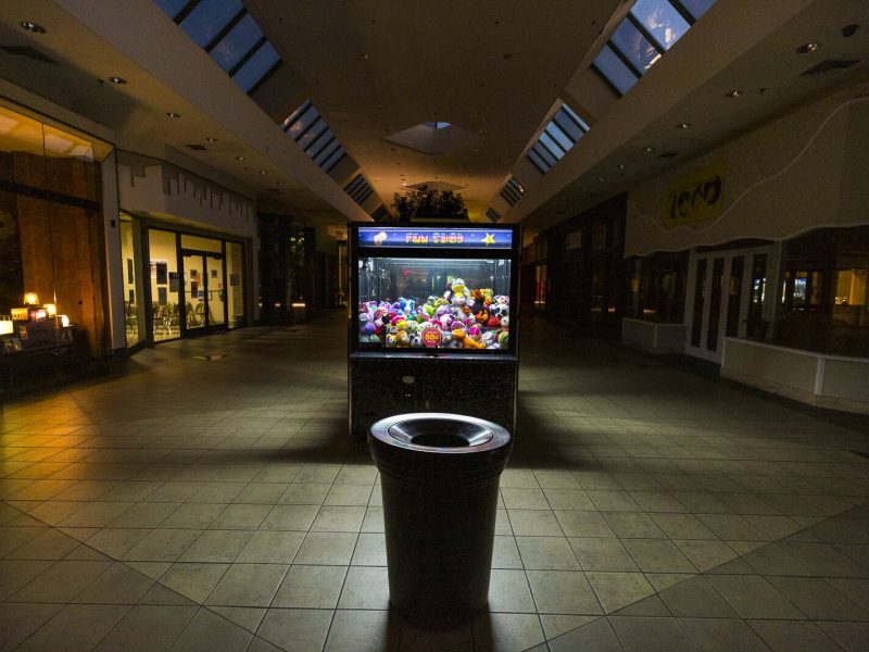 The light of a claw machine casts an eerie light down the hallway of the former Hickory Ridge Mall. The mall is now owned by World Overcomers Church, who are working to repurpose it as a town center. (Ziggy Mack)