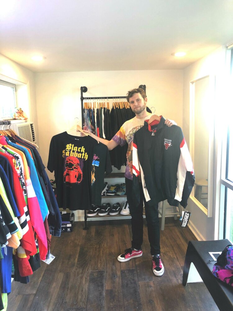 Auston Freeman, Owner of Majik & Co., shows off some pieces from his collection of vintage concert t-shirts and sports gear. As a BOXLOT tenant, he hopes the Edge District will become a destination for all Memphians. (Chris Jones) 