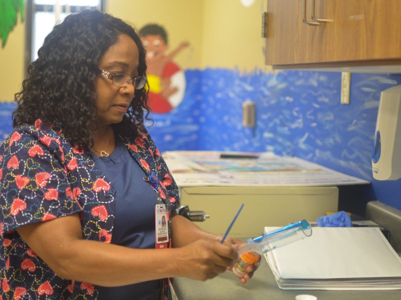 School nurse Patricia McCraw prepares medication for a student at A.B. Hill Elementary. McCraw is part of a school nurse pilot program facilitated by Le Bonheur Children's Hospital, Shelby County Schools and Urban Child Institute. (Cat Evans)