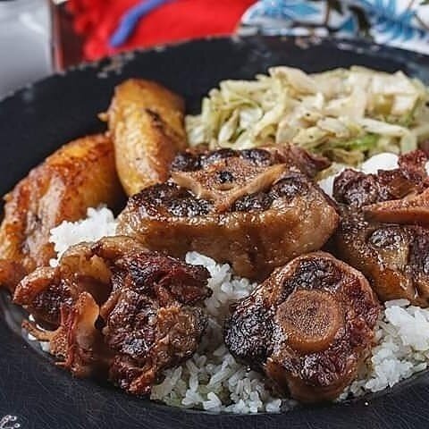 Curried goat is served with rice, steamed cabbage and plantains at Caribbean Flayvahz located in Hickory Hill. (Caribbean Flayvahz) 