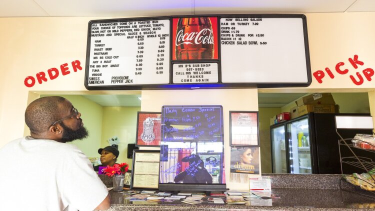 A customer inspects the menu at Ms. B's Sub Shop at 1256 Getwell Road in the University District. (Ziggy Mack)