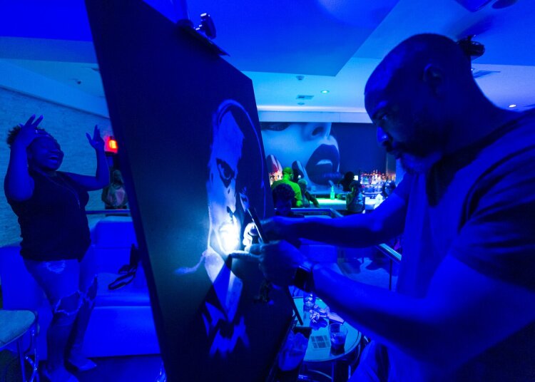 Artist Rodan Ross live paints on music stage at In Love Memphis nightclub and lounge. (Ziggy Mack) 