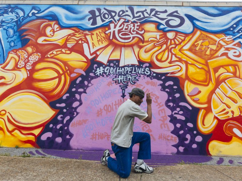 Local musician "Morris" poses in front of a mural by artist Toonkey Berry. (Ziggy Mack)