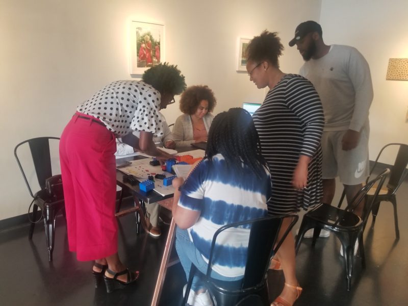 Britney Thornton (second from right) helps built a town in an urban planning workshop held at The CMPLX on July 17. (Baris Gursakal)