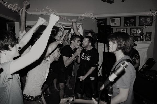 A June 2009 show at the 7house venue had everyone's fist in the air. Left to right: spectators Zac Arnold and Maverick Cross and Wicker band members Paul Rhodes, Brian Vernon & Josh Cannon. (Smith7)