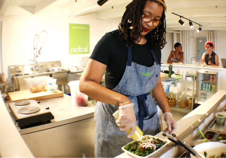 Yolanda Manning, food entrepreneur and general manager of Radical, prepares a salad. Radical is located inside Puck Food Hall and is Diane Terrell and Heather Jamerson's new for-profit, locally-sourced, organic salad venture. (Cole Bradley)