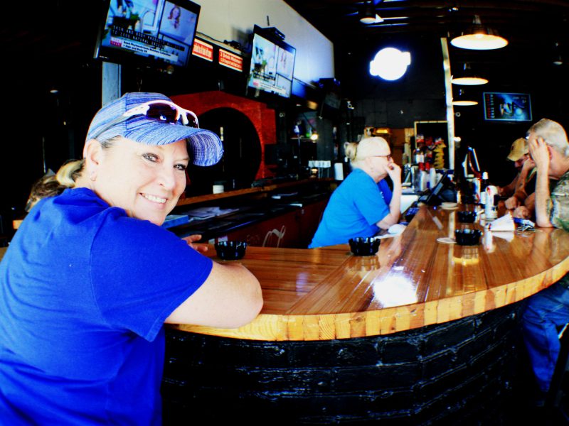 Tami Montgomery, owner of Dru's Bar, sits at the newly remodeled bar and chats with regulars after completing some chores around the business. The location, 1474 Madison Avenue, has been home to a number of LGBT bars since the 1970s. (Cole Bradley)