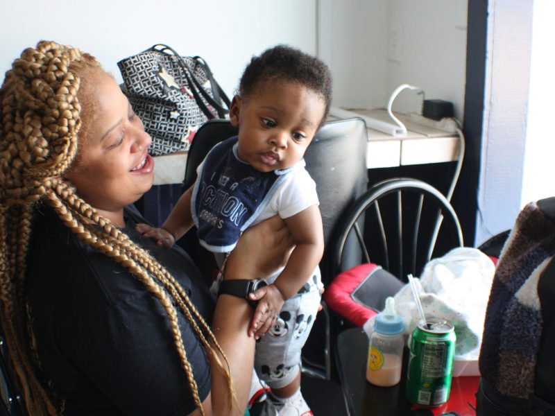 Customer Chimere Miller plays with her son J'iris after enjoying lunch at Riko's Kickin Chicken located at 1329 Madison Avenue in Madison Heights. (Cole Bradley)