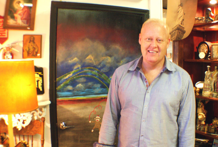 Chuck Guthrie co-owns the Market on Madison antique shop. He's pictured here in front of a custom mural of the Hernando De Soto Bridge. The store is located at 1339 Madison Avenue. (Cole Bradley)