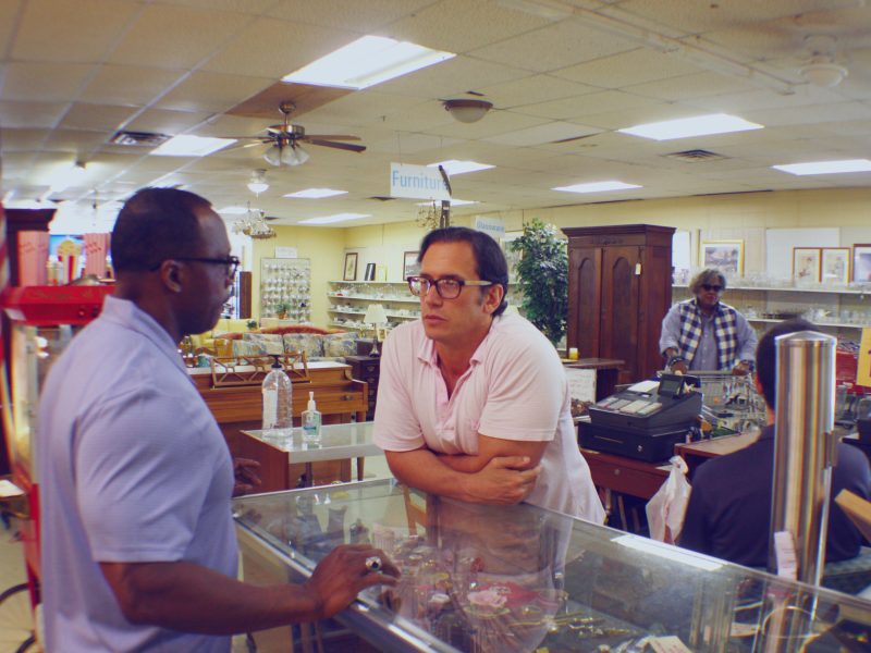 Anatole Williams (L), executive director of Memphis Adult Teen Challenge, and Michael Skouteris, daily operations manager of BAM Thrift Store, discuss store needs. To the right, regular Patricia Jones says hello to the cashier. (Cole Bradley)