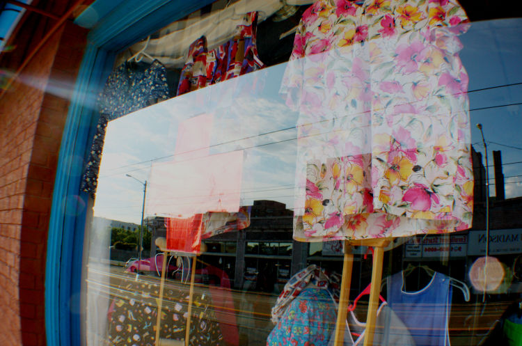 A window display at the BAM Thrift Store advertises scrubs for medical professionals. The store is located in Madison Heights, one of several distinct neighborhoods within the larger Medical District. (Cole Bradley)