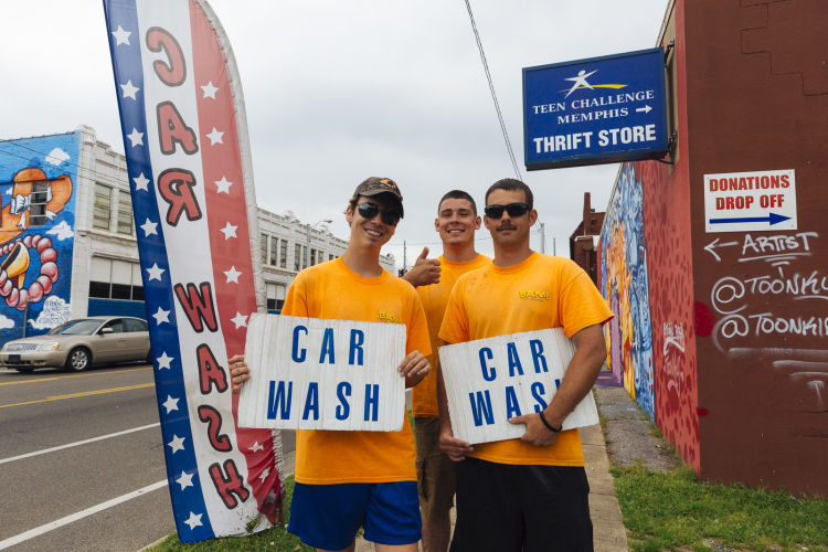 Cecil, Dylan and Curtis advertise the Teen Challenge Memphis cash wash on Cleveland Street near Madison Avenue. (Ziggy Mack) 