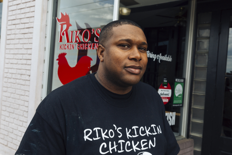 Riko Wiley, owner of Riko's Kickin Chicken, steps out of Upscale Kutz Barber Shop with a fresh new cut. Both businesses are located in Madison Heights. (Ziggy Mack) 