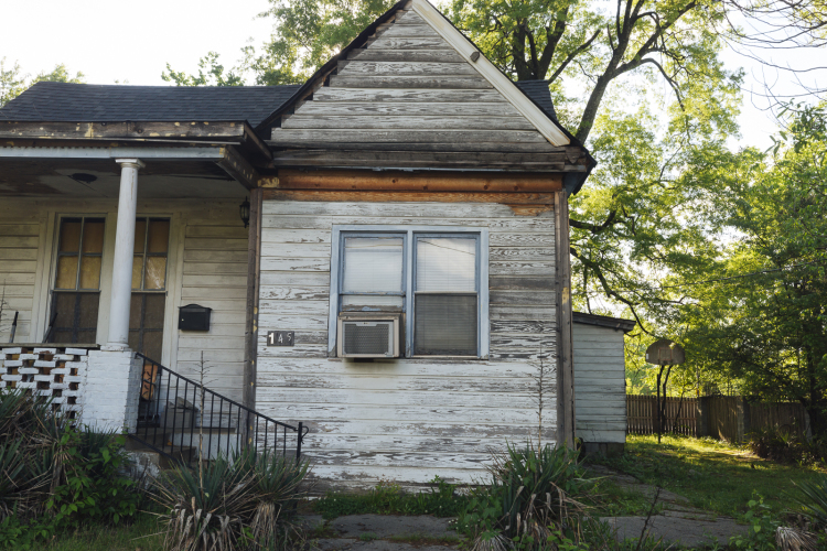 A cozy, worn house with an old basketball goal in the back sits on Watkins Street near Poplar Avenue. (Ziggy Mack)