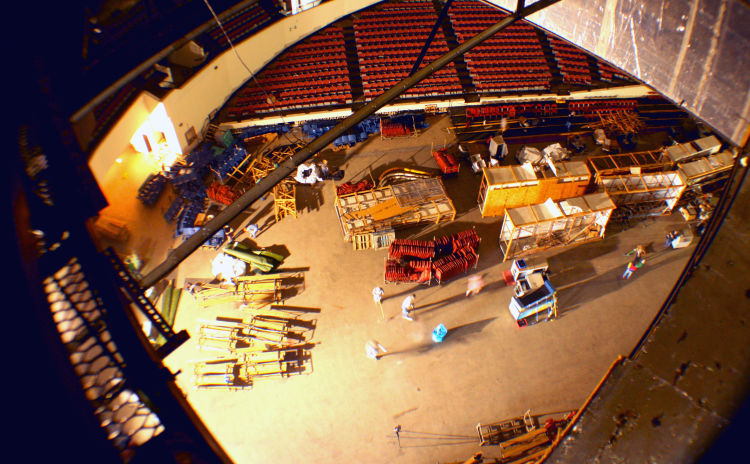 From the Coliseum catwalks, volunteers work on the arena floor below. Their goals included sweeping the floor and organizing items stored in the arena to create a more usable space for future events. (Shelda Edwards). 