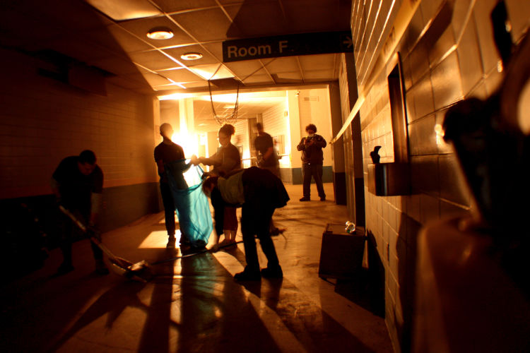 Volunteers work together to sweep 12 years of dust from the Coliseum's lower corridor outside of Room F, where The Beatles held their famous press conference after John Lennon said the band was more popular that Jesus. More than 50 volunteers signed up for the one-day cleanup event. (Shelda Edwards) 