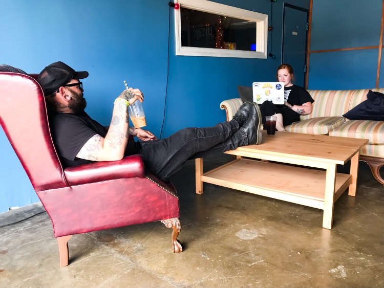 Customers sit in the garage-style side of Launch Process. The bay features a large door that rolls up on nice weather days. (Cole Bradley) 