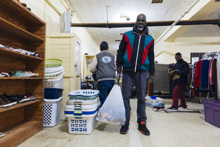 David Clark and others collect donated clothing goods at Catholic Charities, 1325 Jefferson Avenue. (Ziggy Mack)