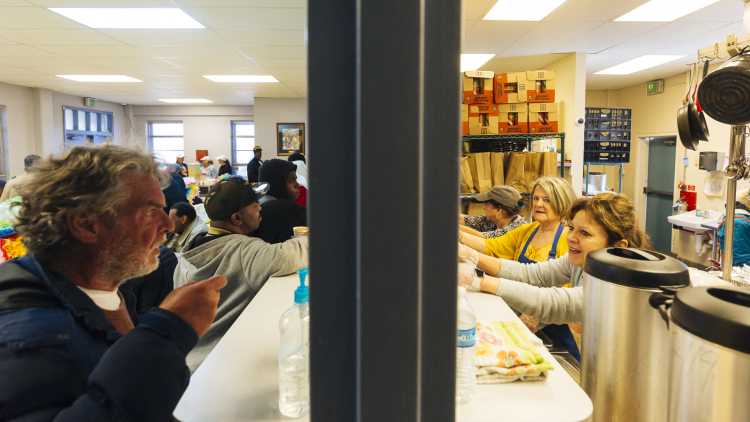 Volunteers serve food to clients at the Society of St. Vincent de Paul of Memphis Ozanam Food Mission. (Ziggy Mack)