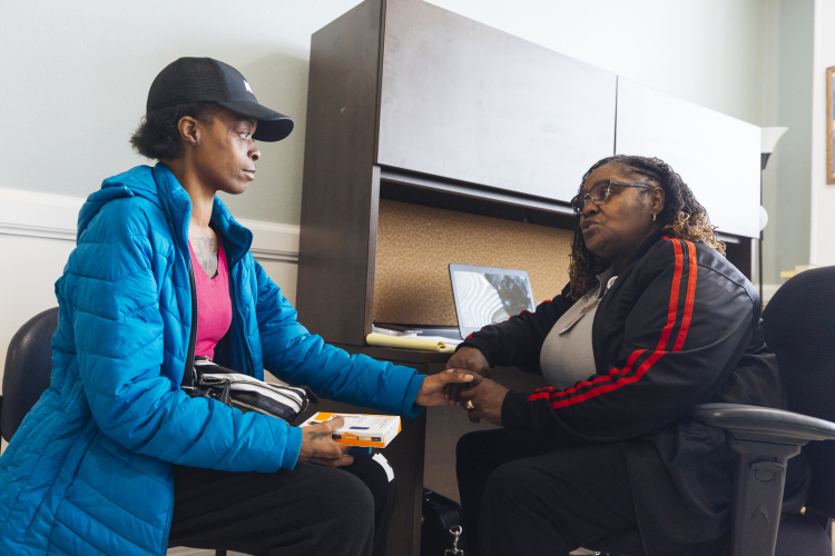 A patient speaks with staff spiritual health advisor Grace Young (right) at the Baptist Operation Outreach clinic, which opened in March to serve the healthcare needs of Memphis' homeless population. (Ziggy Mack)