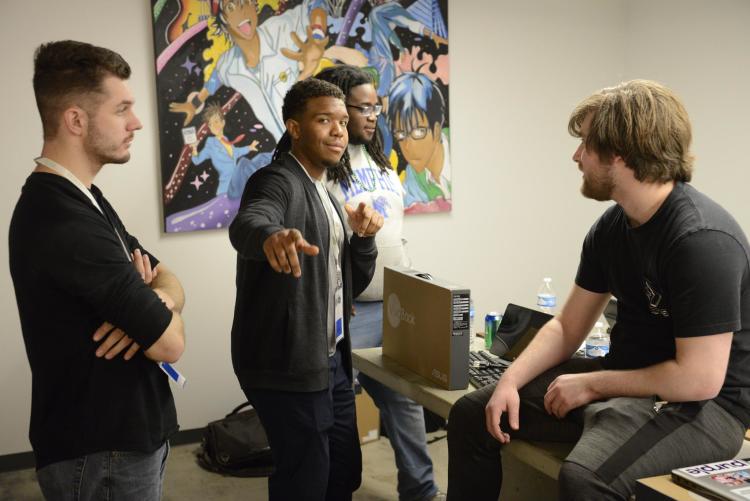 Brandon Ellis, center, in partnership with fellow UofM graduate Kareem Dasilva, has developed a concept for technology that helps the city streamline identification of potholes through machine learning. (Submitted)