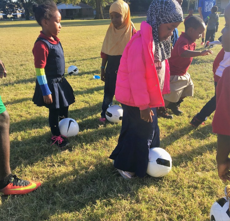 Neighborhood girls learning soccer skills during a Play Where You Stay session at Binghampton Park. The nonprofit developmental soccer initiative has partnered with the Memphis Refugee Empowerment Program to bring accessible soccer programming to neighborhood children, many who are refugees and immigrants. (Submitted)