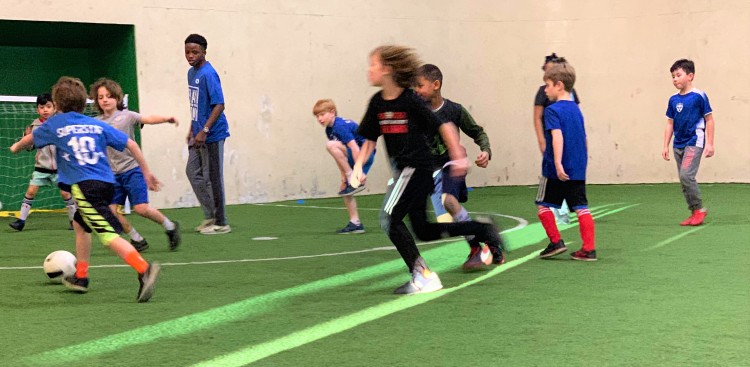 Play Where You Stay coach Ninaruta Fidel, a student at Central High School, looks on as youth participants hone their soccer skills at Greenfield Arena in Midtown, one of three neighborhood sites offering the developmental soccer programming. (Submitted)