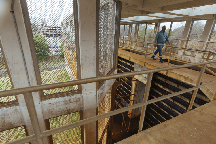An employee walks through the aeration area, where water is aerated and pH is balanced before its sent to customers for drinking. (Ziggy Mack)