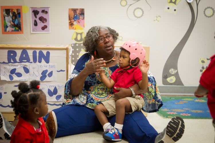 Le Bonheur inclusion facilitator Tereatha Hobbs supports a child during a group activity. (Submitted, Lisa Buser Photography) 