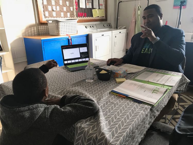 At KIPP Memphis Preparatory Elementary, ALLMemphis partner school specialist Clifford Stockton works one on one with students as an added layer of phonics support beyond the classroom. (Cole Bradley) 