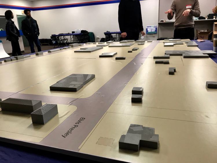 A model of the sparsely populated Whitehaven Plaza was set up for the public design meeting. Stakeholders were asked to build their ideal plaza with additional buildings, greenspaces and other amenities. (Cole Bradley)