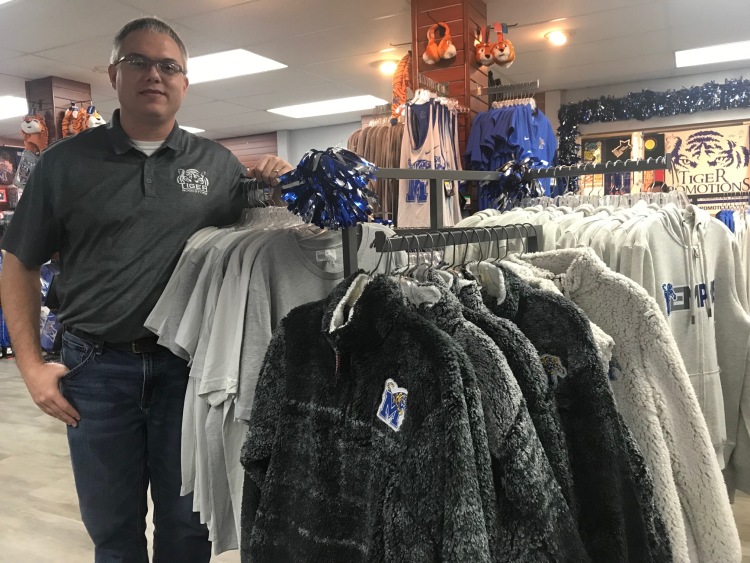 General manager Jeremy Stinson poses with one of this season's hottest items, sherpa jackets, at Tiger Bookstore. (Cole Bradley) 