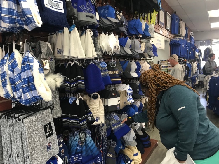 A customer browses hats and knit cap at Tiger Bookstore on Walker Avenue. (Cole Bradley) 