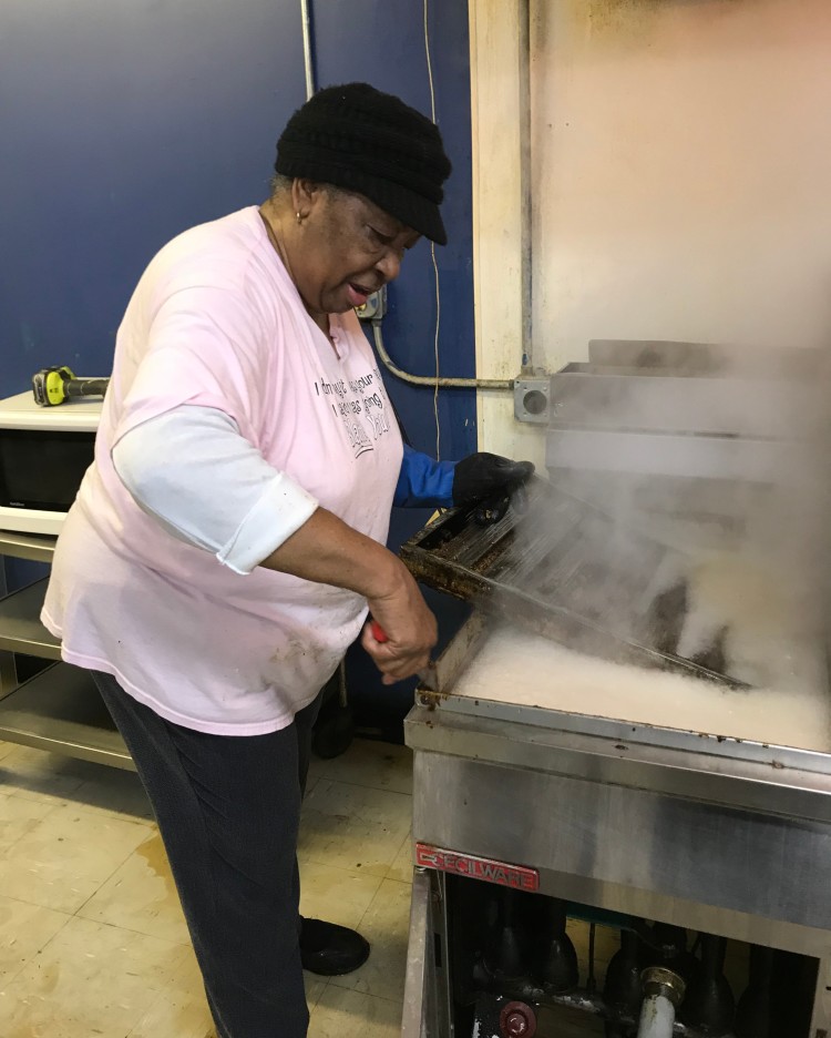 Mama Cookie tests the fryer during the renovation process at 253 Tillman Street. Ford and Mama Cookie met through their church several years ago. (Submitted) 
