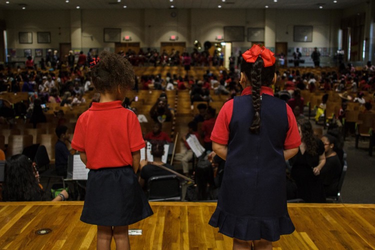 Two kindergarten students prepare to speak at Treadwell Elementary School's Hispanic History Month celebration. (Renier Otto)