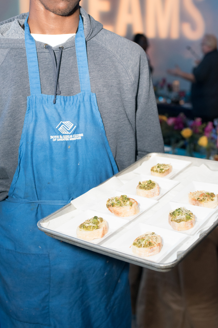 A member of Boys and Girls Clubs of Greater Memphis' culinary arts training program offers an hor d'oeuvre at the Feast of Dreams. (Demarcus Bowser)