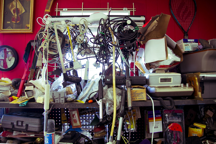 Wired appliances hang in front of a window at the Summer Outlet thrift store. (Natalie Eddings)