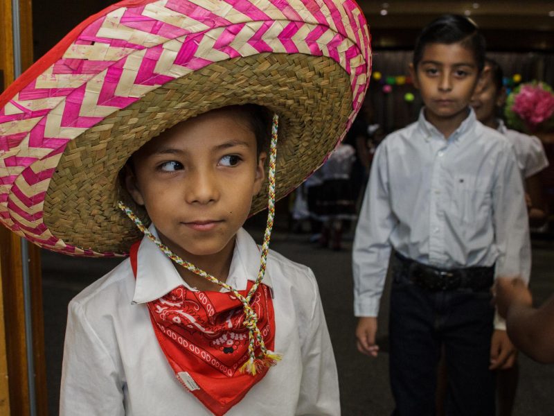 A first-grade student peeks around the corner at a pop-up performance held at Treadwell Elementary School as his classmates line up behind him. (Renier Otto)