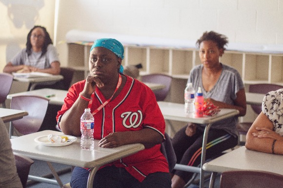 Parent Sharon Bates listens to tips for encouraging conversation with her two year-old daughter, Savannah. (Agape)
