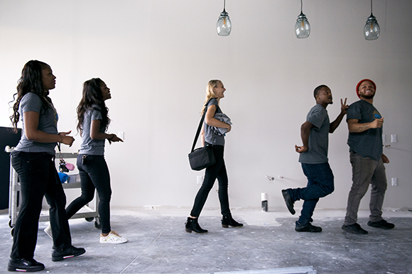 Inspire Community Cafe owner Kristin Fox-Trautman, center, walks with her team, from left, Charlena Branch, Jacqueline Chandler, Tevin Whitley, and Terrance Whitely, inside the restaurant which is currently under construction in Binghampton. (Brandon Dill)