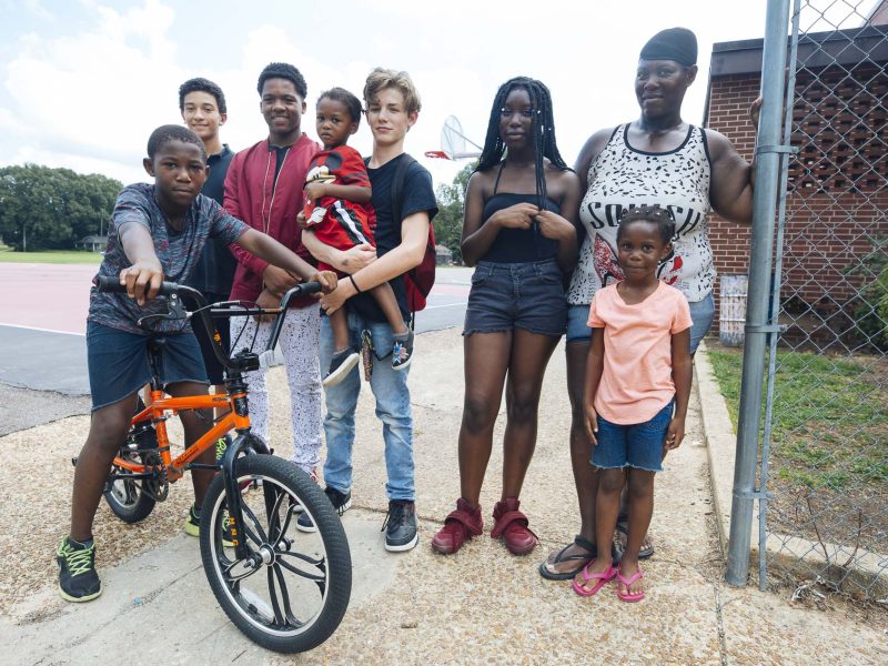 (Left to right) Ladarius Shields, Richy Phan, Ceric Hicks, Hayden Williams, London Johnson (held), Robin Tate, Alice Shields, and Lonel Shields (front) pose for a portrait at Treadwell Middle School. (Ziggy Mack)