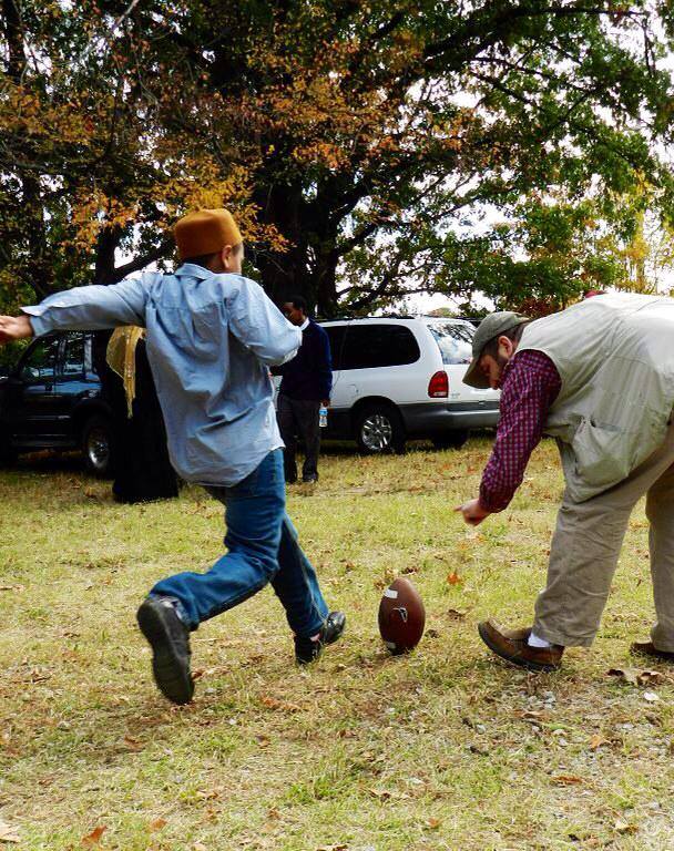 Men play football at a recent holiday gathering. The center is a space for spirituality but also a place for fun and community. (Memphis Dawah) 