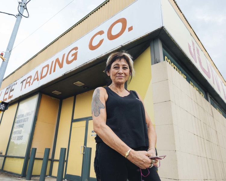 Heights resident Deborah Nahinu stands in front of Jun Lee Trading Co., a staple at Summer and National for more than 30 years. (Ziggy Mack)