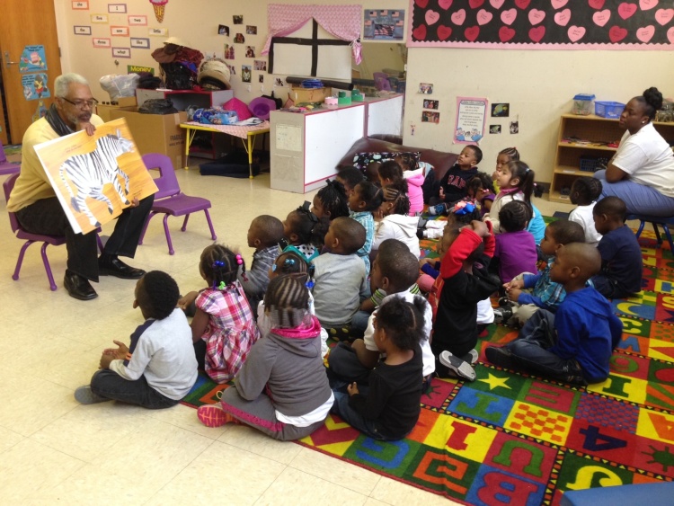 Children listen to a story as part of Cornelia Crenshaw Memorial Library's Real Men Read program. The exterior of Crenshaw and Randolph libraries are in need of attention, but inside, they're bright and active centers of community. (Memphis Library Foundation)