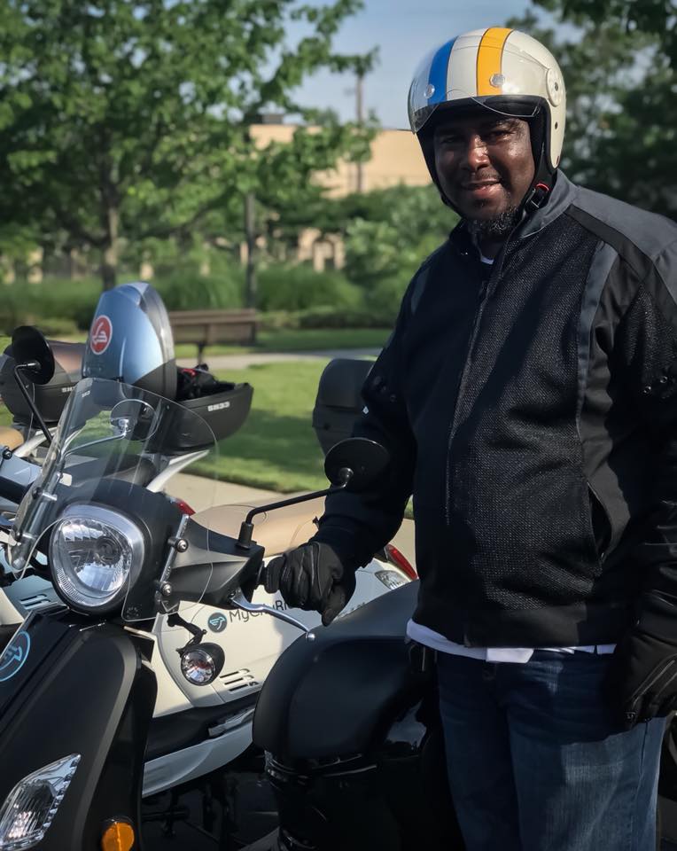 Don Henson, security manager with the Southern College of Optometry and his scooter acquired through My City Rides.