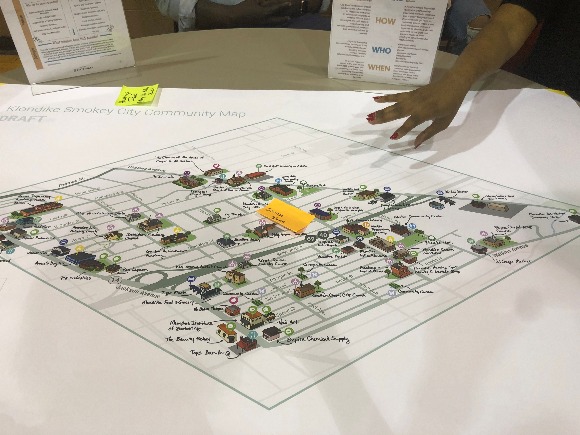 Cortney Thomas with Whole Child Strategies Inc. explains the Klondike-Smokey City community asset map and asks residents to check it for accuracy. (Shelda Edwards)