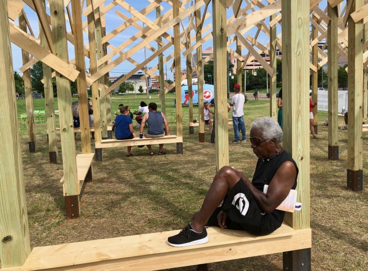 Robert Wiseman relaxes on a bench at the launch party for the Treedom Memphis art installation in Uptown-Pinch. Wiseman has been a part of the neighborhood since 1963. (Cole Bradley)
