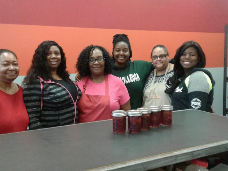 Women from a Straight Farm Whitehaven's canning class pose with their finished products. Once the skill of preserving is learned, the women can use it to can and preserve produce at home. (Kimberly Dobbins)