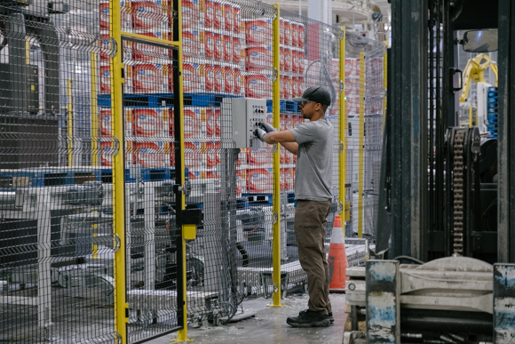 A KTG employee operates machinery that packages the final paper products. (Brandon Dahlberg)