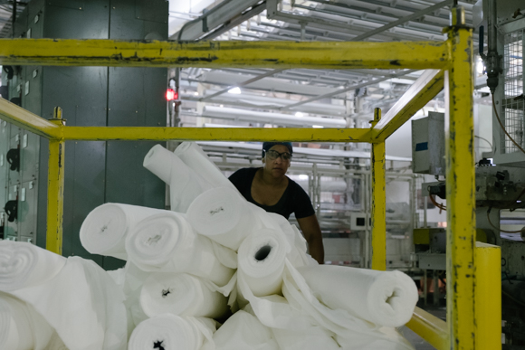 A KTG employee prepares to load logs onto a machine. (Brandon Dahlberg)
